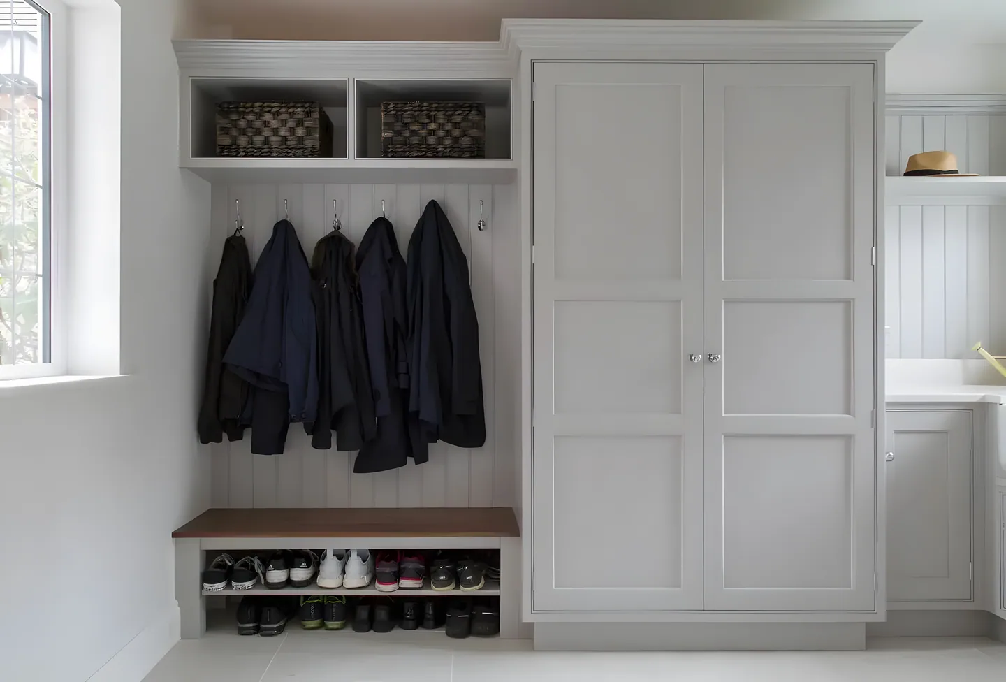 A boot room with coat hooks and shoe storage