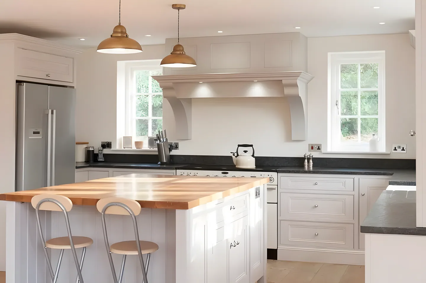 A cream painted kitchen with an oak topped island