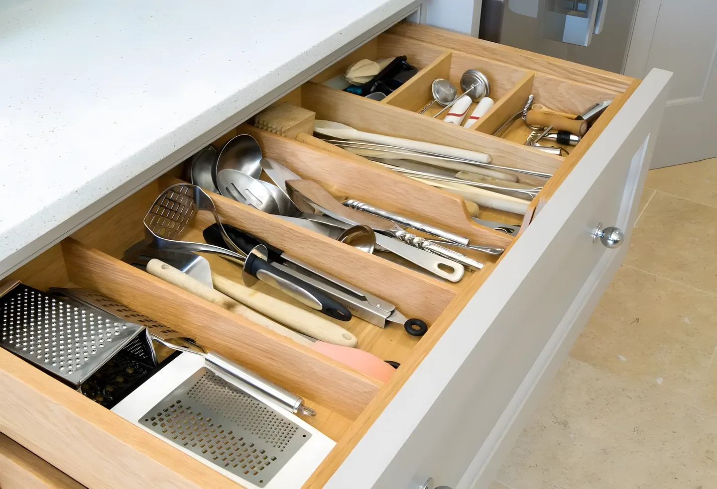 An oak cutlery drawer with dovetailed joints and quality handles