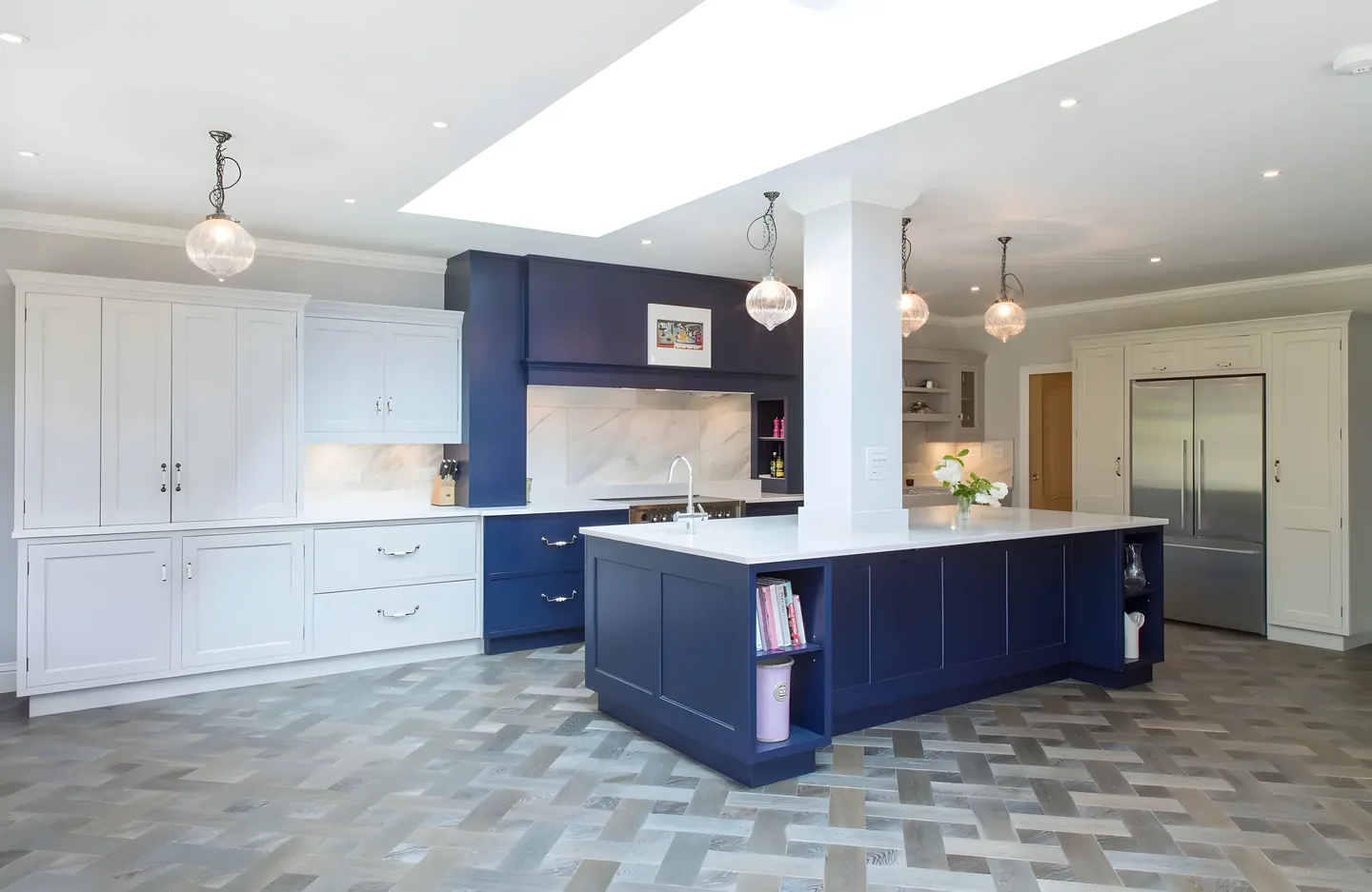 A deep navy painted island and range hood beside a patterned tile floor