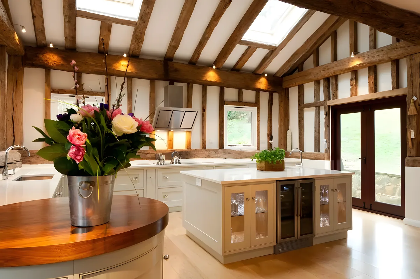 A curved oak island in a timber framed room