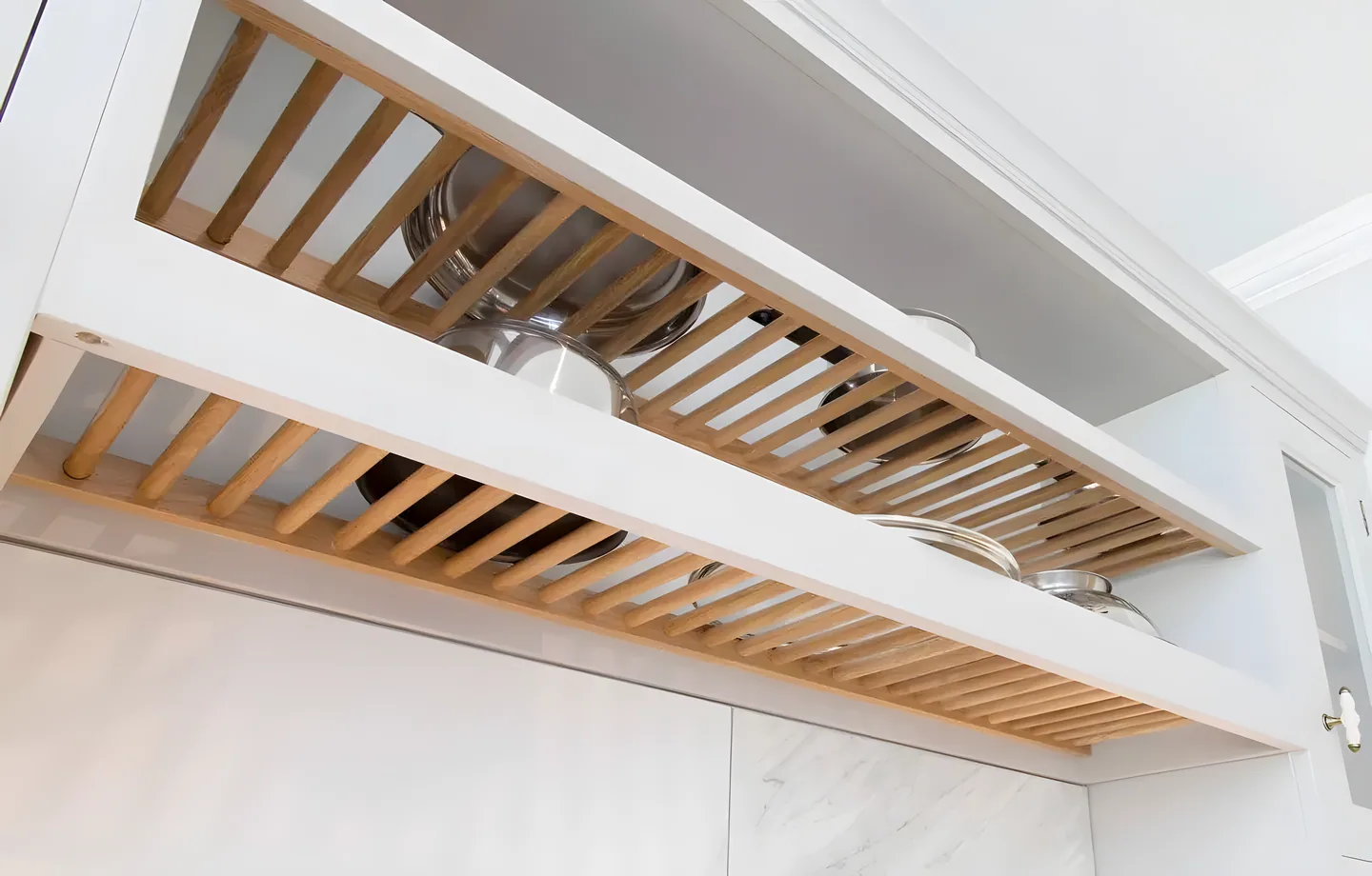 An oak plate rack above a worktop